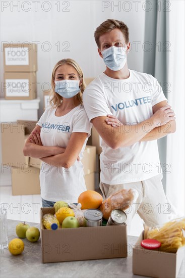 Front view volunteers posing while preparing food donations