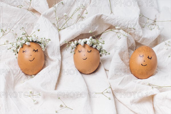 Row easter eggs with decorative flower wreaths textile
