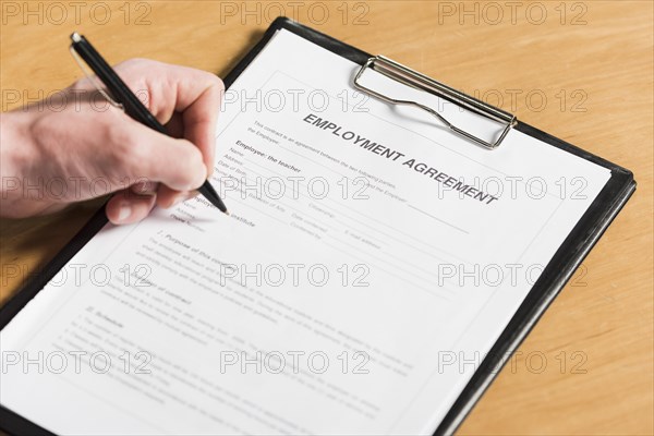 High angle man signing contract new job