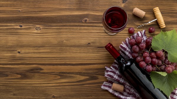 Top view wine bottle with glass wooden background