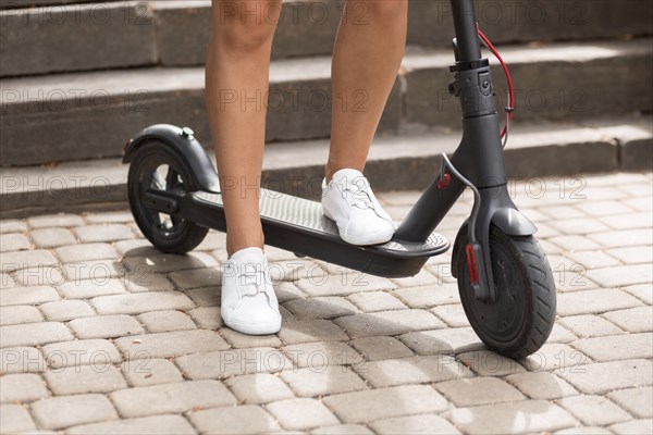 Front view woman riding electric scooter