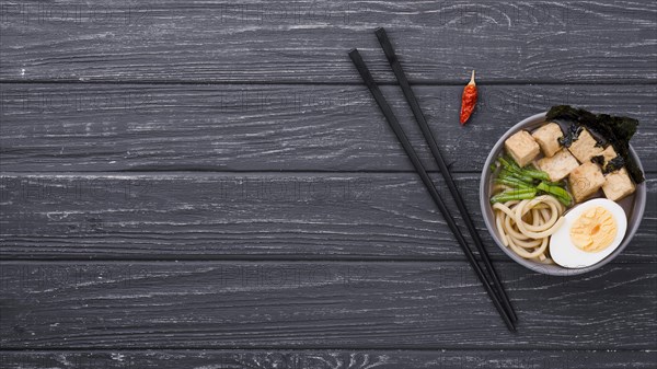 Top view ramen healthy soup with egg chopsticks