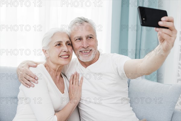 Elder couple making selfie