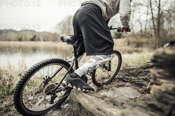 Cyclist riding bike near lake