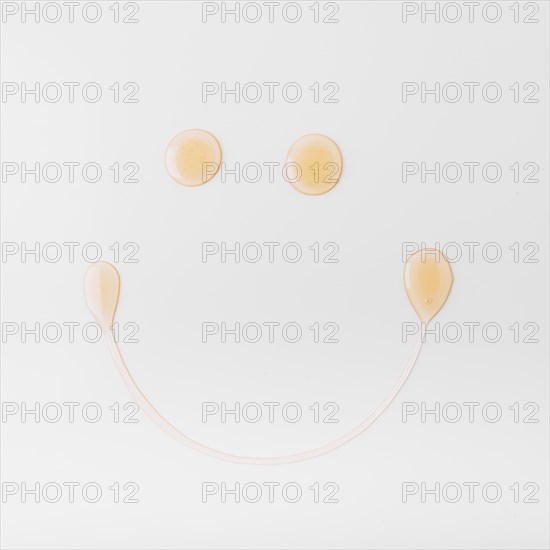 Smiley face made with honey white background