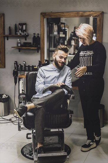 Customer showing magazine barber