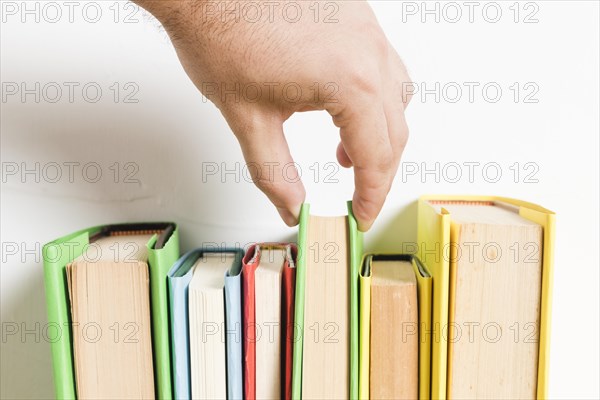 Person choosing book from shelf