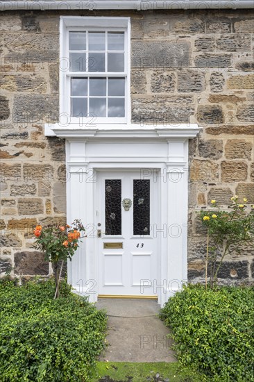 White front door on an old stone house