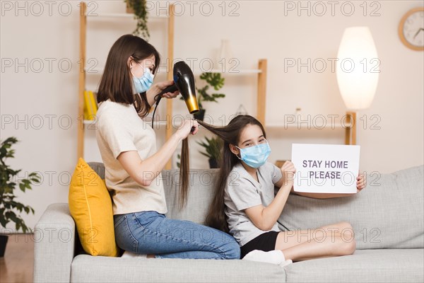 Side view mom drying girl hair