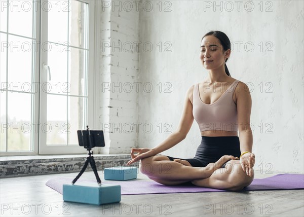 Young woman showing meditation technique new vlog