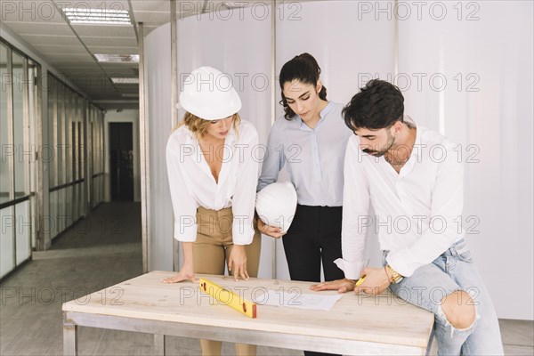 Group engineers leaning table