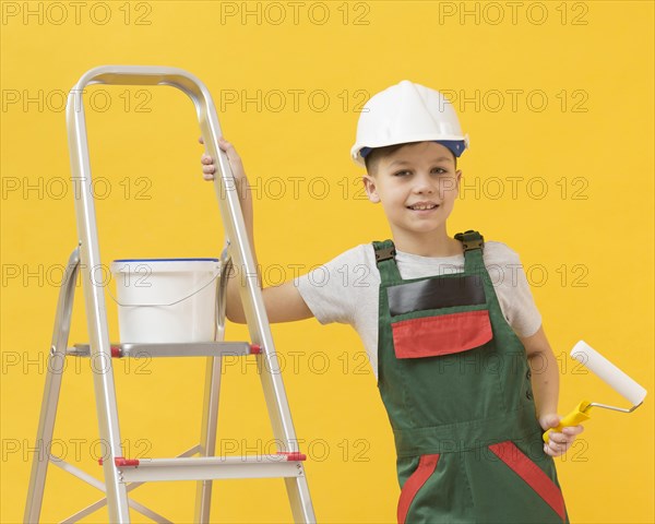Cute boy posing with ladder