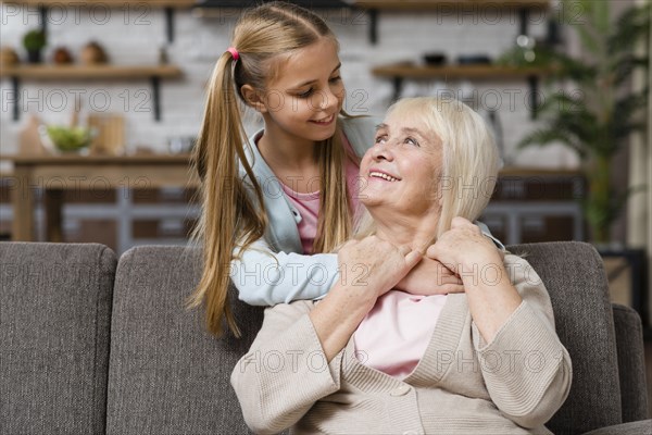 Grandmother granddaughter looking each other medium shot