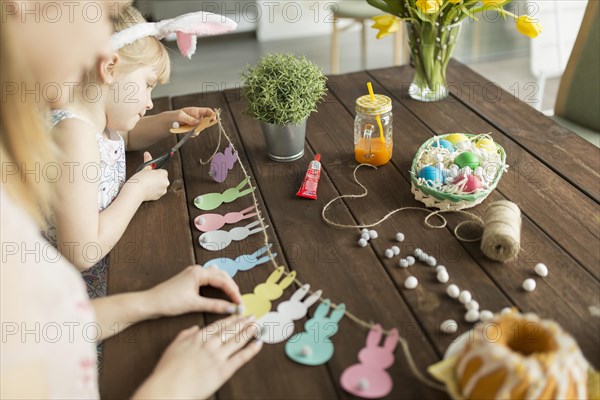 Mother daughter making garland