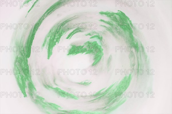 Artistic green paint strokes circular shape white background