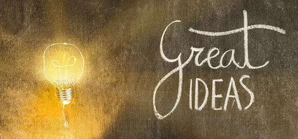 Illuminated light bulb with great ideas text written chalkboard