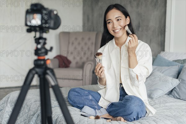 Pretty woman vlogging about make up