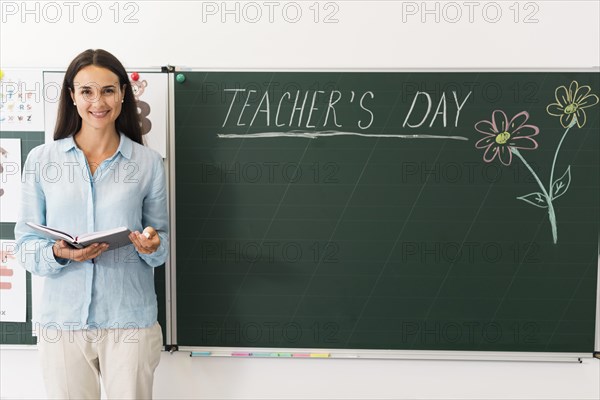 Teacher standing blackboard with copy space