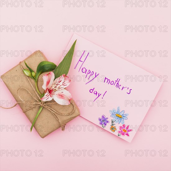 Happy mothers day inscription with flower gift