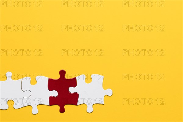 Red white puzzle piece with yellow background