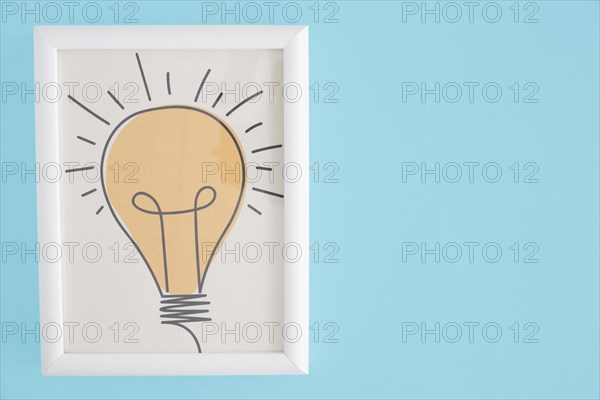 Yellow hand drawn light bulb white frame blue background