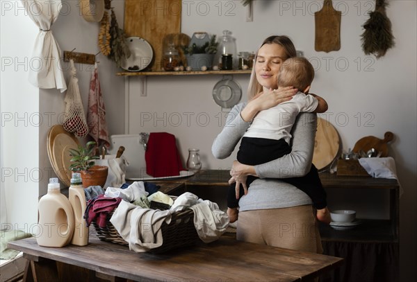 Medium shot woman holding kid