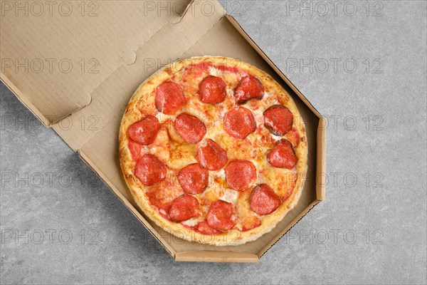 Top view of classic pepperoni pizza in cardboard box