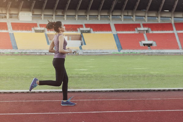 Girl running athletic track