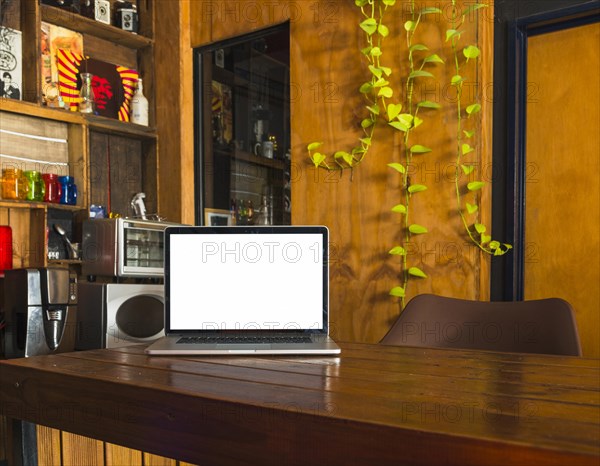 White blank screen laptop dining table home