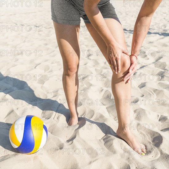 Female volleyball player hurting her knee while playing