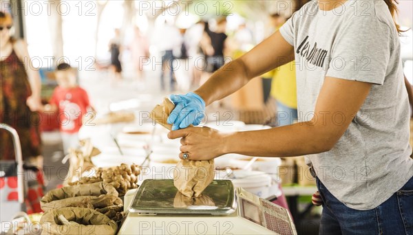 Woman seller packing food her customer market