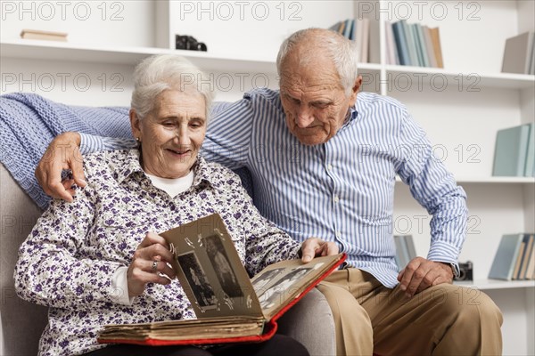 Mature couple looking into album