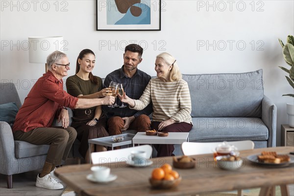 Medium shot happy family clinking glasses