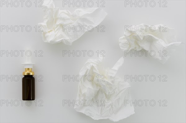 Crumpled white paper dropper bottle white background