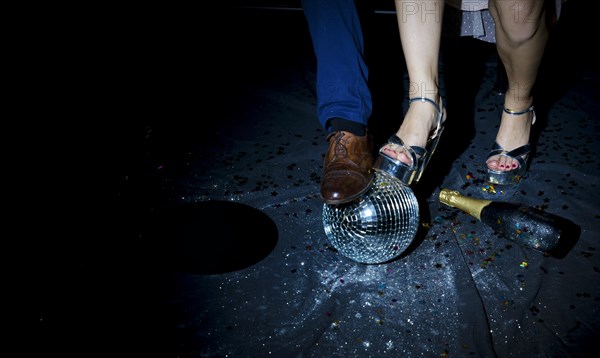 Couple standing floor with disco ball