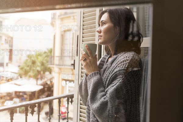 Side view woman holding cup coffee