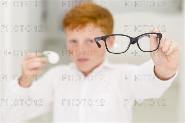 Close up boy showing black frame eyeglasses