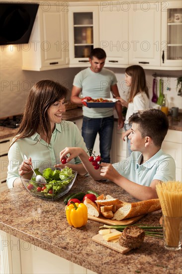Family spending time kitchen preparing food