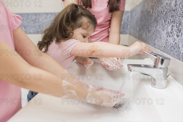 Close up girls washing hands