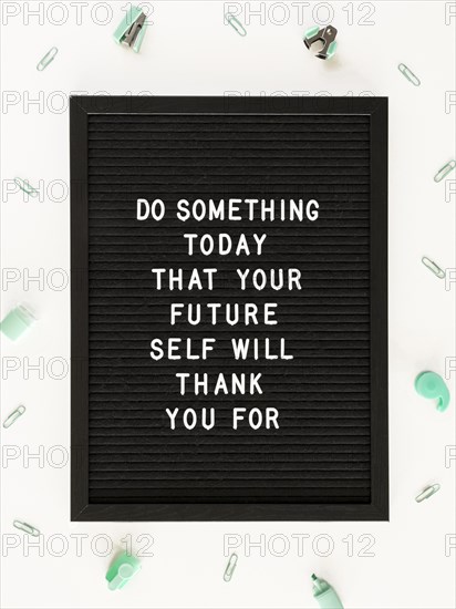 Black motivational text board flat lay