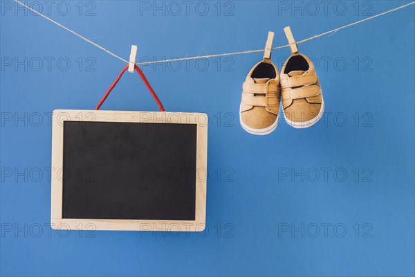 Baby concept with slate shoes clothesline