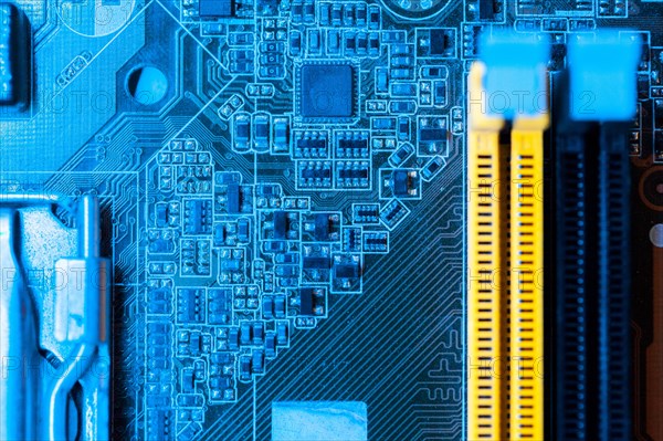 Blue themed motherboard with slots close up