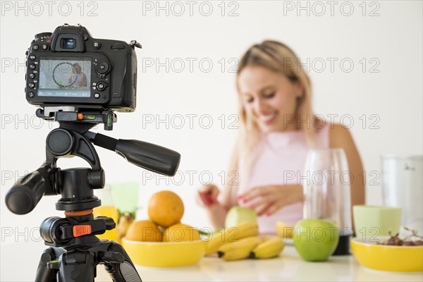 Blonde influencer recording nutrition food