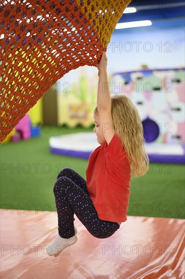 Girl climbing playground side view