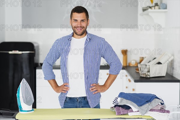 Male home preparing iron clothes