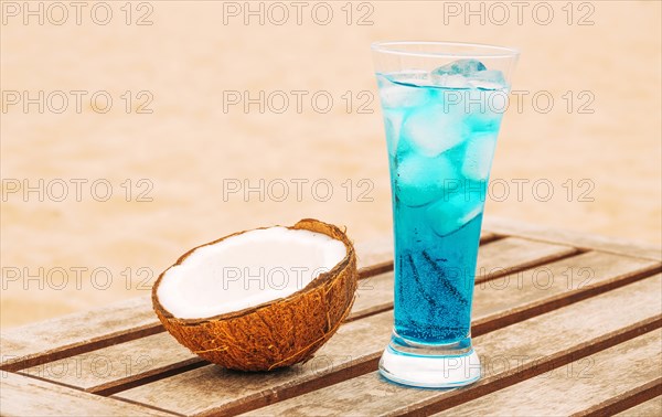 Cracked coconut glass bright blue drink wooden table