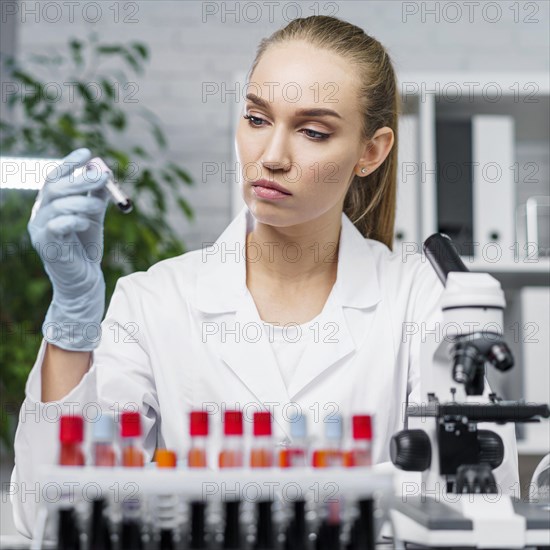 Front view female researcher laboratory with test tubes