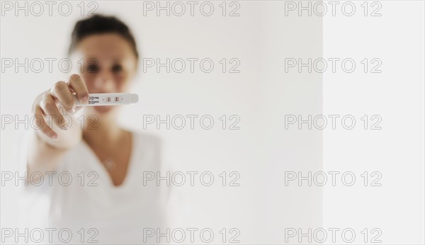 Woman showing positive pregnancy test