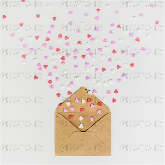 Envelope with small paper hearts white table