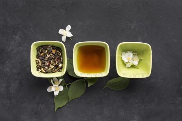 Row healthy tea ingredient white jasmine flower black surface